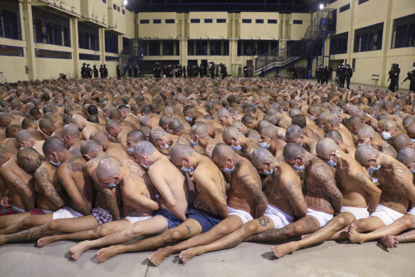 Inmates wearing masks are crammed into the central area of Izalco prison in San Salvador, El Salvador, during a security operation.
