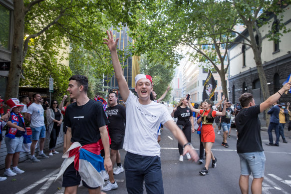 Taking it to the streets: fans of Djokovic outside his lawyers’ offices.