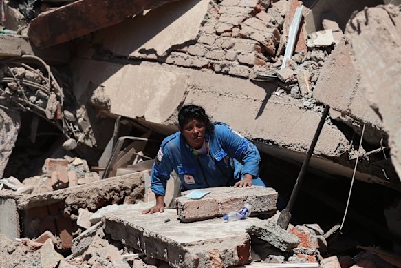 A rescue worker searches for survivors.