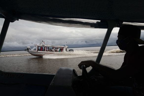 A medical team from Manacapuru travel the Amazon by boat to test residents for coronavirus in communities unreachable by road, in Ilha Marrecão, Brazil. 