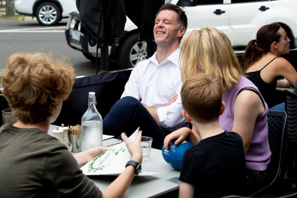 Winning grin: Chris Minns enjoys Sunday brunch with his wife Anna and their three sons.