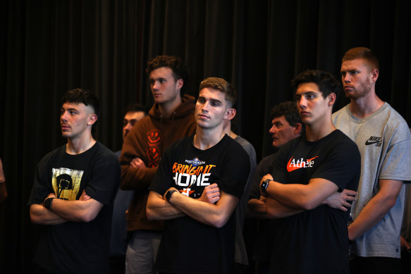 Essendon players look on during Brad Scott’s first press conference as coach on Friday.
