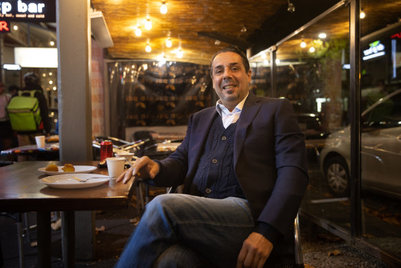 Sam Manasfi, originally from Lebanon, enjoys a cigarette after a Ramadan buffet at Mandina.