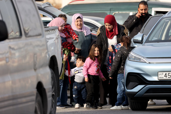 People arrive at the Jordanian side of the border as others wait in their cars on Saturday, after a ban on crossings into Syria.