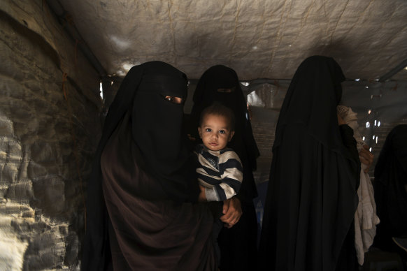 Australian Zahra Ahmed with her son Ibrahim in the al-Hawl camp in north-east Syria in 2019. They were among many Australian women and children detained for their association with Islamic State fighters.