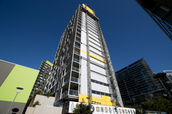 Cladding is removed from the Distillery apartment tower at Pyrmont in inner Sydney. 