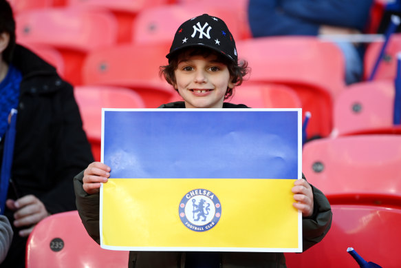 A Chelsea fan holding a banner indicating their support of Ukraine at Wembley Stadium last year. 