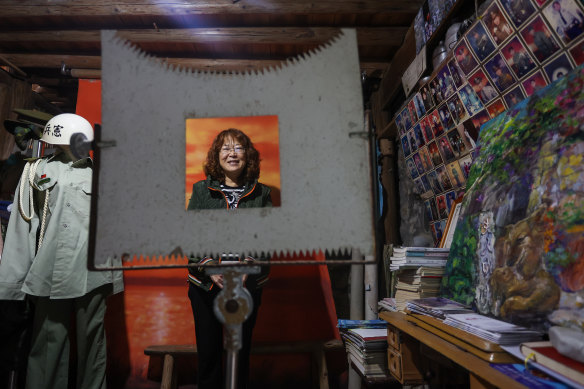 Wang Chun-chin reacts to the camera inside her family’s gallery and coffee shop popular among Taiwanese soldiers on the island of Matsu, close to Fujian, China.