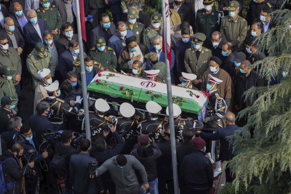 Military personnel carry the flag-draped coffin of Mohsen Fakhrizadeh at his funeral on Monday.