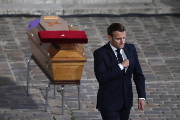 French President Emmanuel Macron leaves after paying his respects by the coffin of slain teacher Samuel Paty in the courtyard of the Sorbonne university in Paris in October 2020.