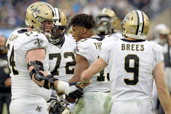 Michael Thomas, centre, celebrates with teammates after scoring a touchdown against the Titans.