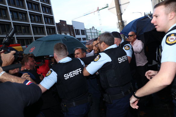  Supporters of Jarryd Hayne push the media back after Hayne was sentenced at Newcastle Court on May 6, 2021.  