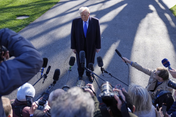 US President Donald Trump speaks with reporters on the South Lawn of the White House before boarding Marine One at the weekend.