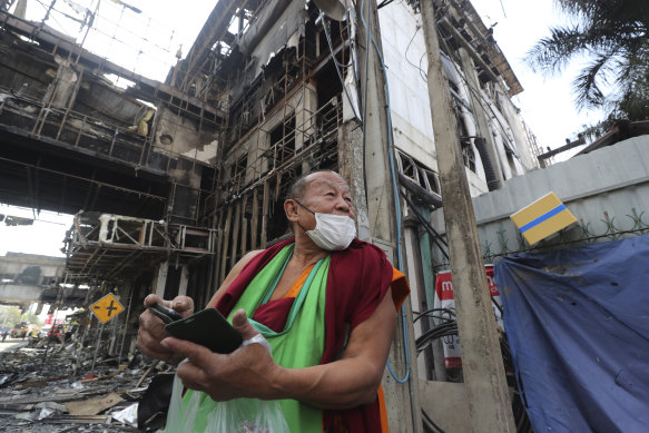 A Thai Buddhist monk visits the site as the search for bodies resumes.