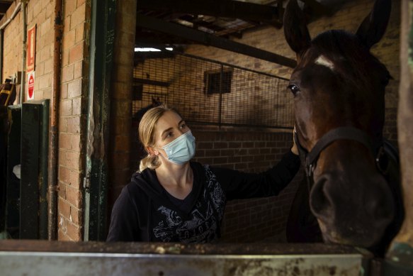 Katrina Haslam is 28 weeks pregnant and can no longer do her job as track rider for race horses. She is waiting for permission to cross the border to join her partner in Brisbane.