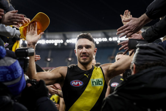 Shane Edwards leads the Tigers off the ground after his 300th game.