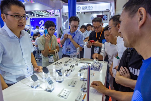 The participants sell diamonds at a trade fair for synthetic diamonds in Henan, China. 