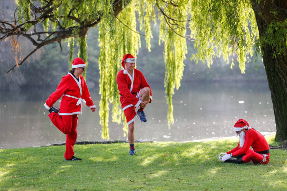 Joe Grabin (left), Brian Inwards and Jo Stavers cool down after a Christmas Day fun run in Coburg. 