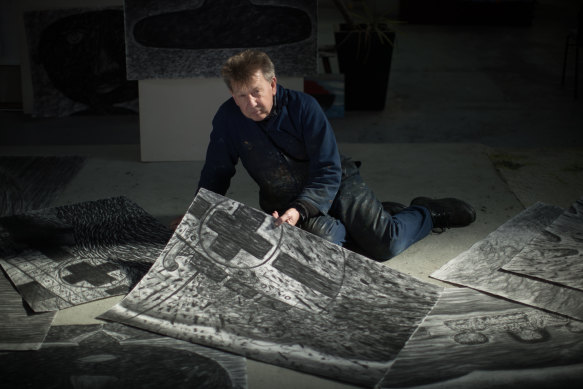 Dean Bowen in his studio with some of his Centaur drawings. 