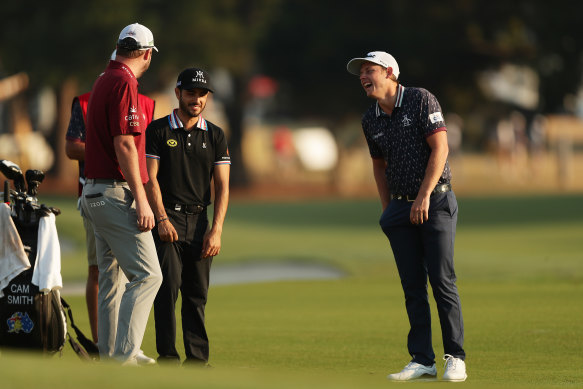 Smith shares a laugh with friend Marc Leishman and Mexico's Abraham Ancer at the Australian Open in Sydney.