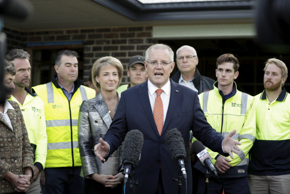 Minister Michaelia Cash and Prime Minister Scott Morrison with tradies in April 2019.