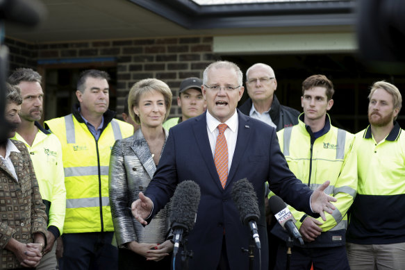 Minister Michaelia Cash and Prime Minister Scott Morrison with tradies in April 2019.