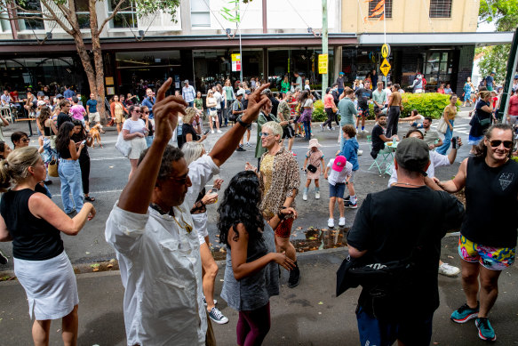 With the road closed to cars, people take to the street in Surry Hills.