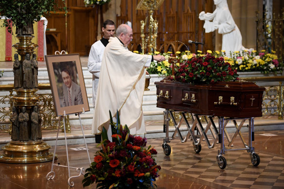 Father Brian Lucas blesses John Brennan’s coffin during his funeral at St Mary’s Cathedral on Wednesday.