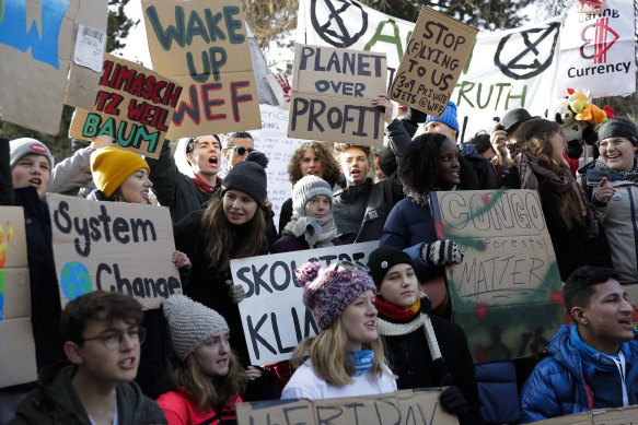 Swedish climate activist Greta Thunberg, centre with blue-grey striped hat, attends a Friday for Future protest in Davos, Switzerland, in January.