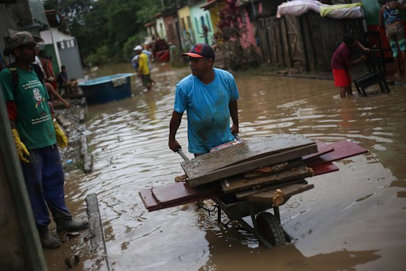 Residents cleaned out their homes in Itapetinga, Brazil, as the flood waters subsided. 
