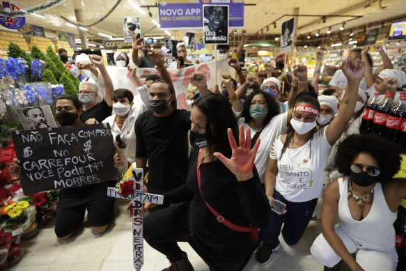 Activists, including members of Black Lives Matter, demonstrate in a Brasilia Carrefour against the killing of black man João Alberto Silveira Freitas at a Carrefour supermarket in Porto Alegre the night before.