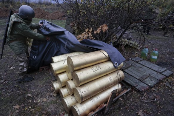 A Ukrainian soldier covers artillery shells for a howitzer gun in Donetsk in eastern Ukraine.