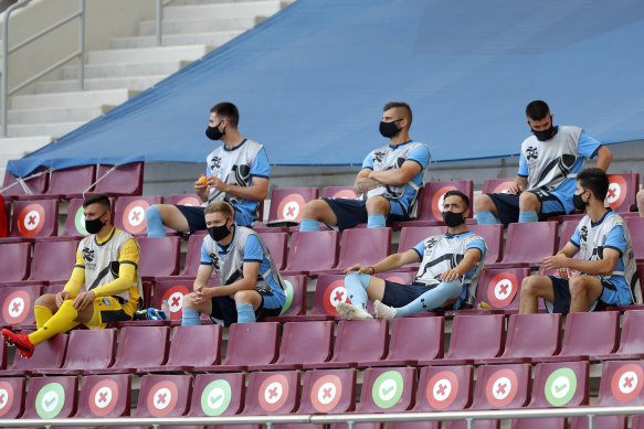 Sydney FC's substitutes sit in the stands, socially distanced, at Doha's Khalifa International Stadium.