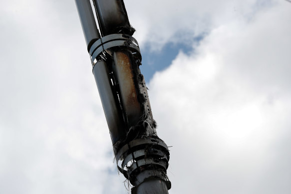 A fire-damaged telecom tower, reported in local media as being a 5G network mast, stands in Birmingham, England.
