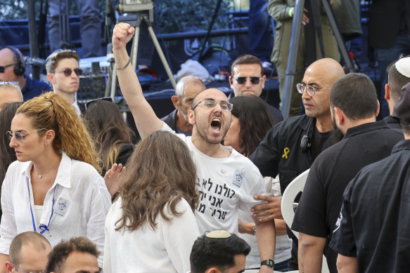 A man shouts as Israeli Prime Minister Benjamin Netanyahu speaks during a ceremony marking the Hebrew calendar anniversary of the Hamas attack on October 7 last year.