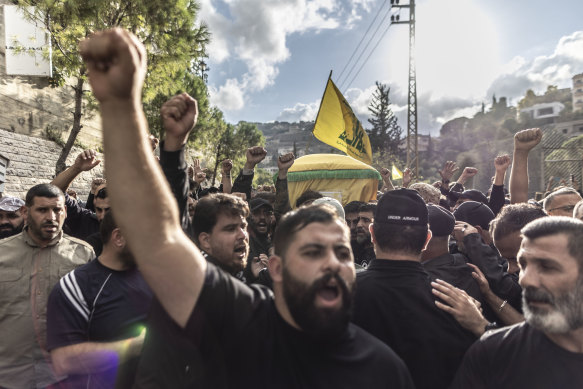 Hezbollah supporters chant slogans against US and Israel while carrying the coffin of a Hezbollah militant killed on Tuesday during clashes against IDF in the southern border of Lebanon.