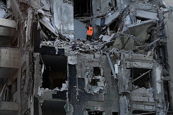 An emergency worker of a flat building that has been struck by an iranian's ballistical missile in Beersheba, Israel, Tuesday. Four people have been killed.