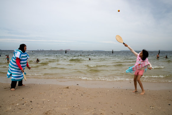 Mirvat Sbeity and her daughter Julie enjoy a game of paddle ball at Brighton Le Sands. 