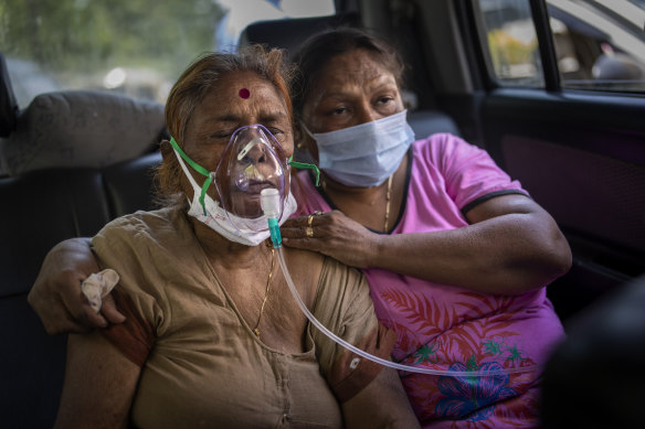 COVID-19 patient receives oxygen inside a car provided by a Gurdwara, a Sikh house of worship, in New Delhi.