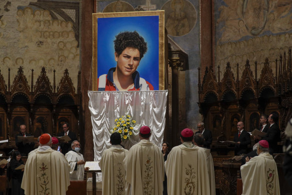 An image of Carlo Acutis is unveiled during his beatification ceremony celebrated by Cardinal Agostino Vallini in the St Francis Basilica, in Assisi, Italy, in 2020.