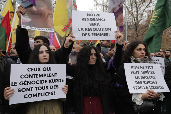 Activists hold placards demanding freedom for women and the Kurdish people outside the Kurdish culture centre in Paris on Saturday.