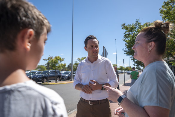 Nathan Hagarty, Labor candidate for Leppington, speaks to voter Denise Norman and her son William, 14.