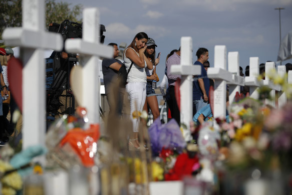 People visit a makeshift memorial at the site of a mass shooting at a shopping complex, in El Paso in August.
