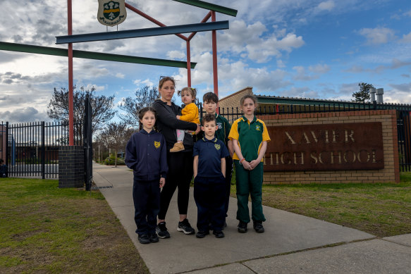 Tara Greenfield and her family in front of Xavier High School in Albury.