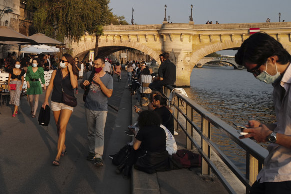 People enjoy the outdoors along the Seine in Paris on Friday.
