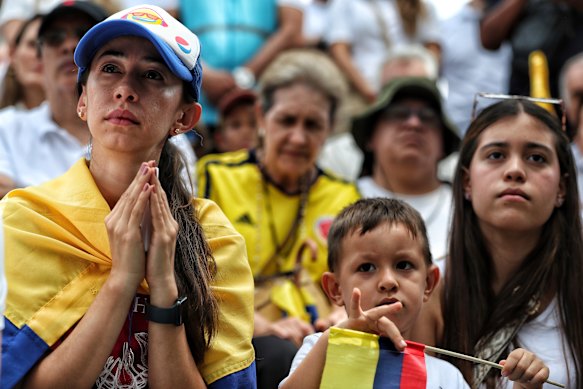 Colombians gather to pray for Uribe Turbay on Sunday.