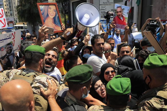 Families of the victims of the 2020 explosion at the port of Beirut are pushed back as they try to reach parliament in 2021.