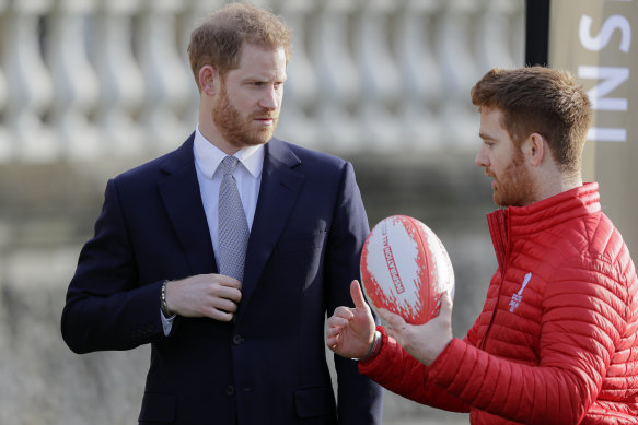 Britain's Prince Harry chats to Rugby League World Cup 2021 ambassador James Simpson.