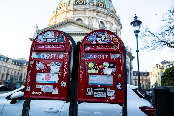 Two Danish red letterboxes stand in front of The Marble Church in Copenhagen, Denmark, on December 16.