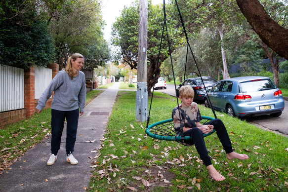 Good news for some: Rachael Robinson with her son Lewis on Dudley street, Balgowlah.  